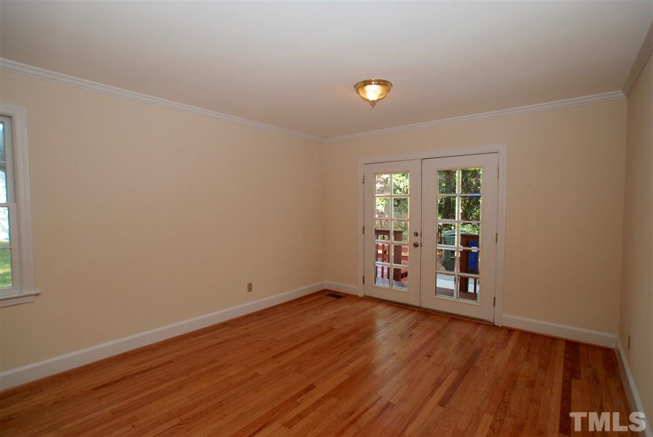 3404 Cherry Lane Raleigh, NC 27607 - Photo 9 of 19 an empty room with wooden floor and windows