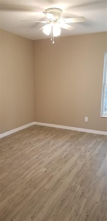 326 Clark Street Inverness, FL 34452 - Photo 14 of 19 a view of a room with wooden floor and fan