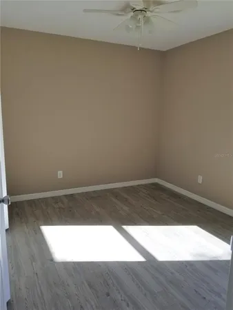 a view of an empty room and wooden floor