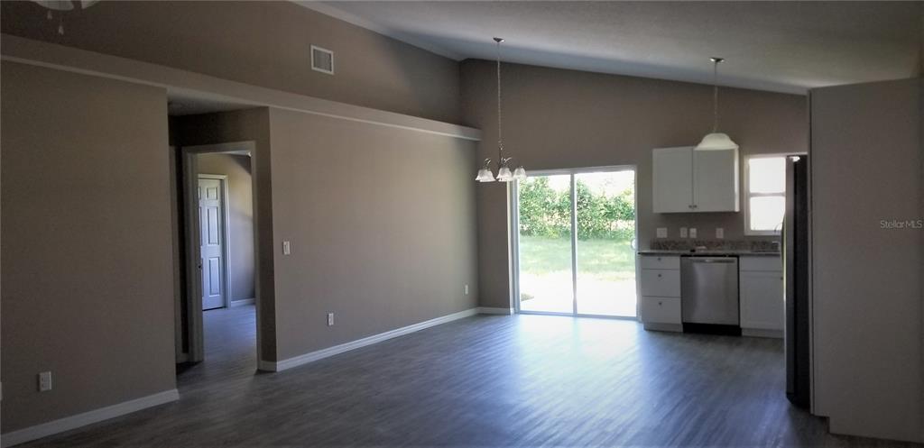 326 Clark Street Inverness, FL 34452 - Photo 6 of 19 a kitchen with a refrigerator and a stove top oven