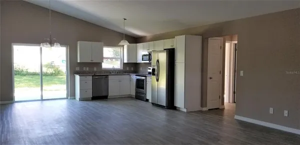 a kitchen with stainless steel appliances a refrigerator sink and cabinets