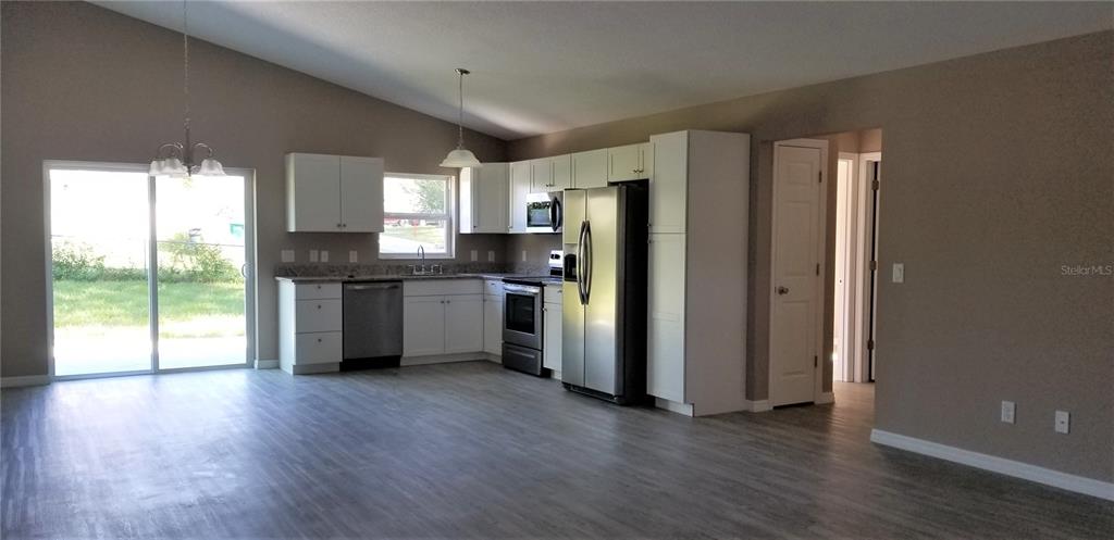 326 Clark Street Inverness, FL 34452 - Photo 7 of 19 a kitchen with stainless steel appliances a refrigerator sink and cabinets
