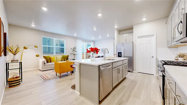 a kitchen with stainless steel appliances granite countertop a stove and a sink