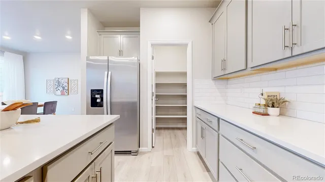 a kitchen with kitchen island a sink stainless steel appliances and cabinets