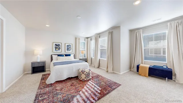 a spacious bedroom with a bed and couch