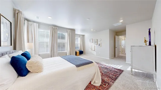 a bedroom with a bed and a large window