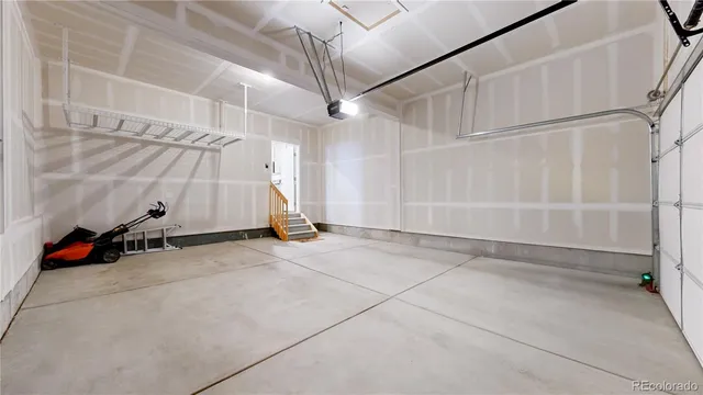 an empty room with wooden floor and white walls