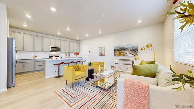 a living room with furniture and kitchen view