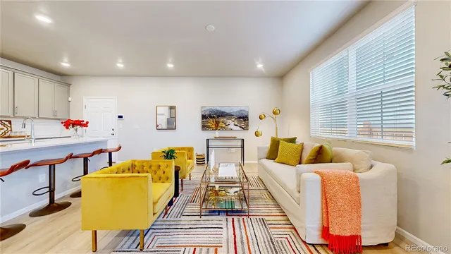 a living room with furniture and kitchen view
