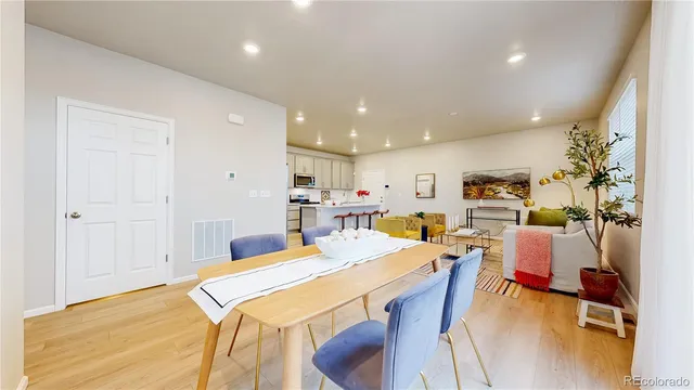 a very nice looking dining room with furniture and a wooden floor