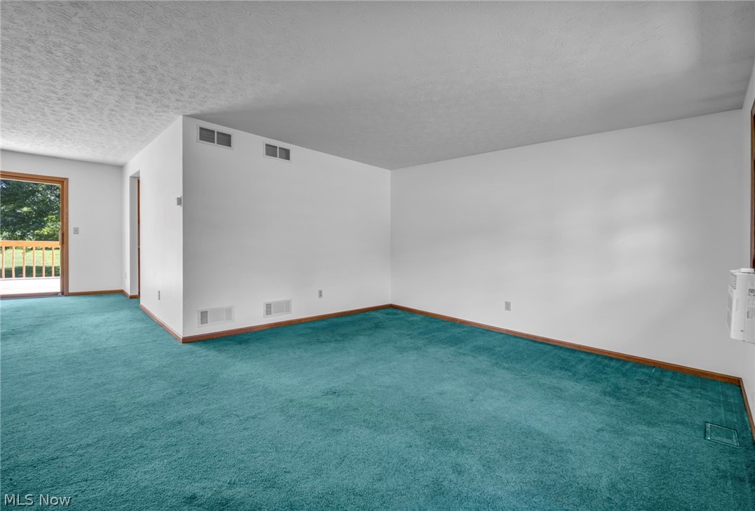 2642 Blake Road Wadsworth, OH 44281 - Photo 14 of 50 White walls with wood trim and teal carpeting