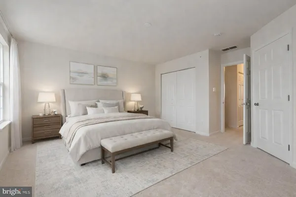 a bedroom with a bed and a night stand