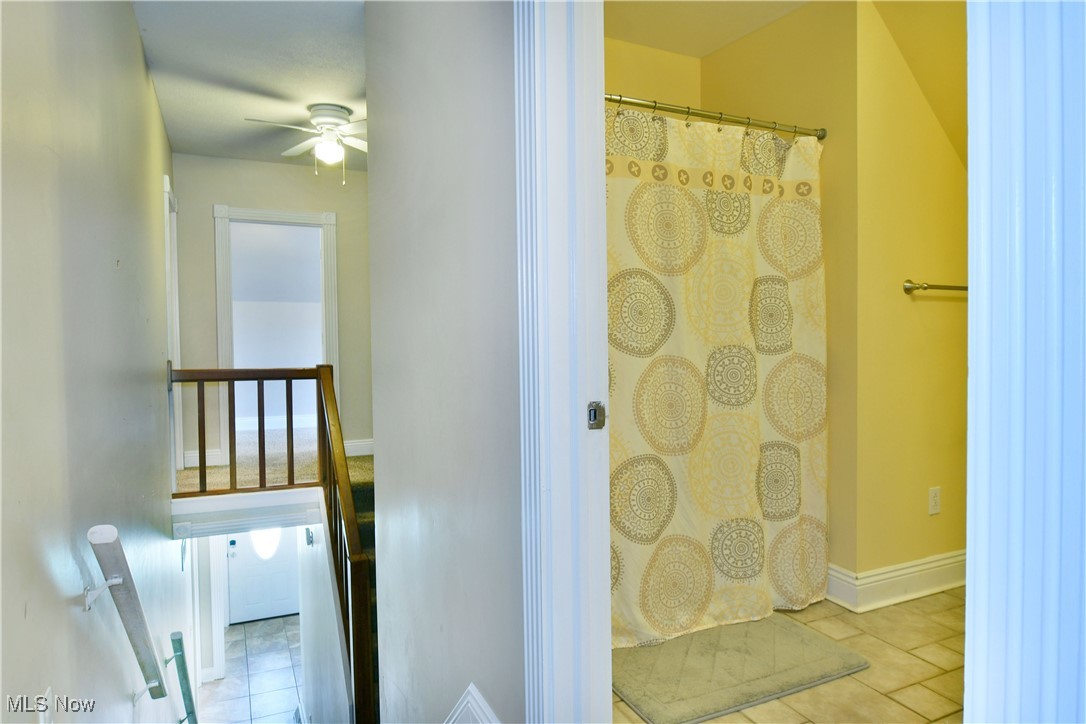 1735 Pleasant Valley Road Girard, OH 44420 - Photo 29 of 44 Bathroom with a ceiling fan, tile patterned flooring, curtained shower, and baseboards