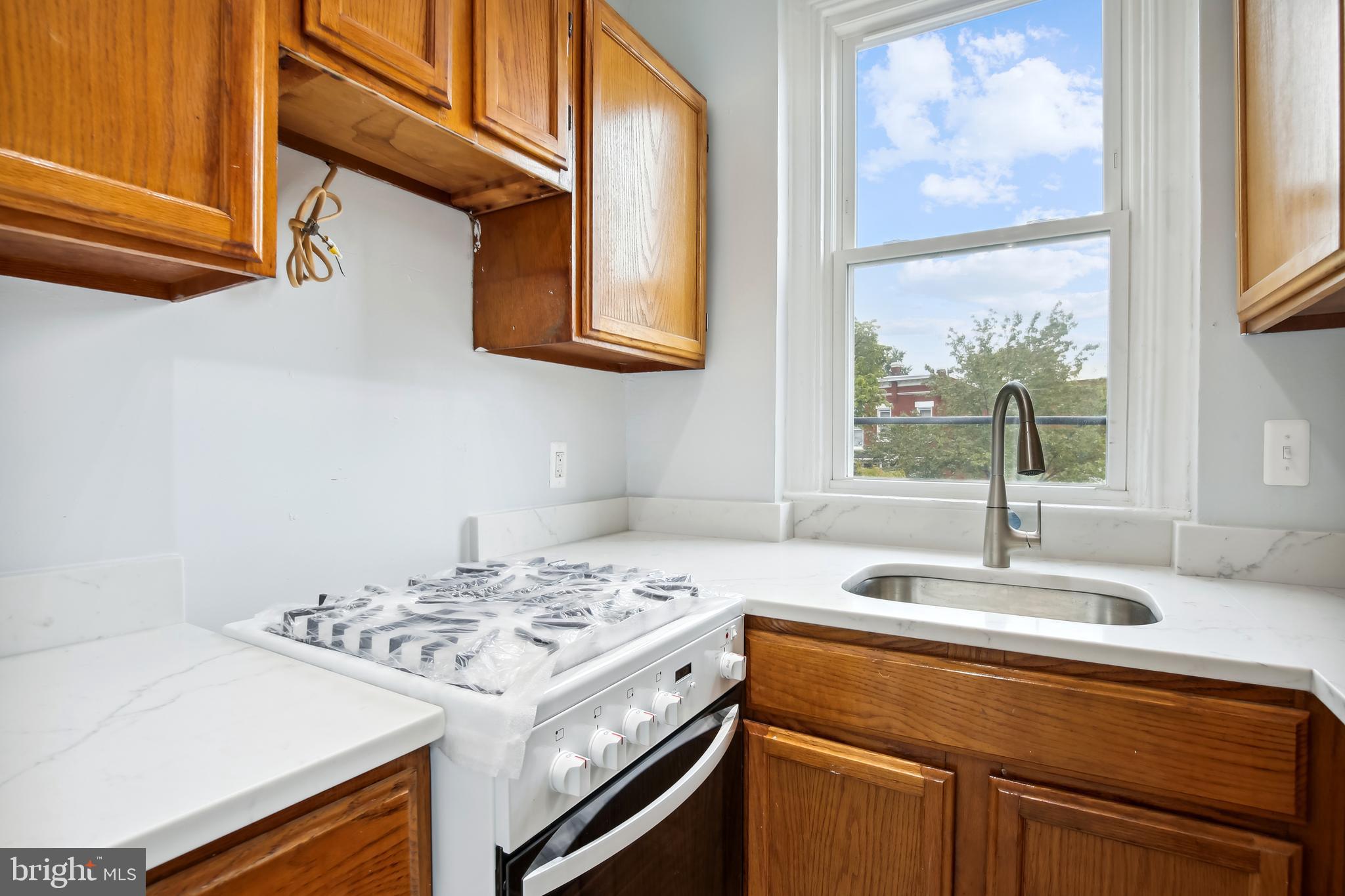 3701 13th Street Northwest, Unit 102 Washington, DC 20010 - Photo 11 of 38 a kitchen with a stove and a sink