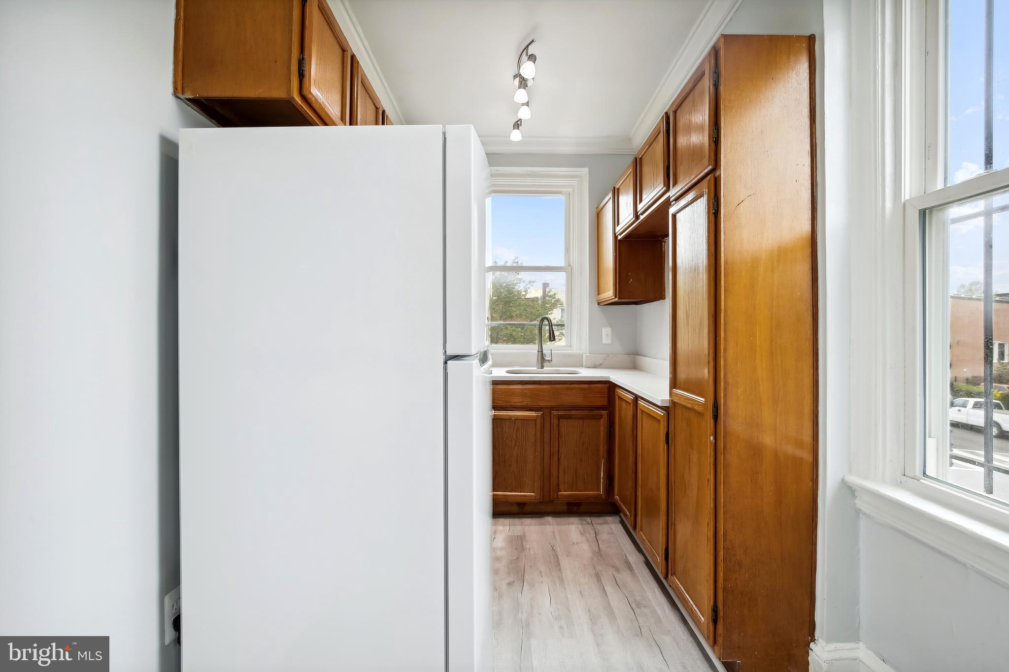 3701 13th Street Northwest, Unit 102 Washington, DC 20010 - Photo 13 of 38 a kitchen with a refrigerator and a sink