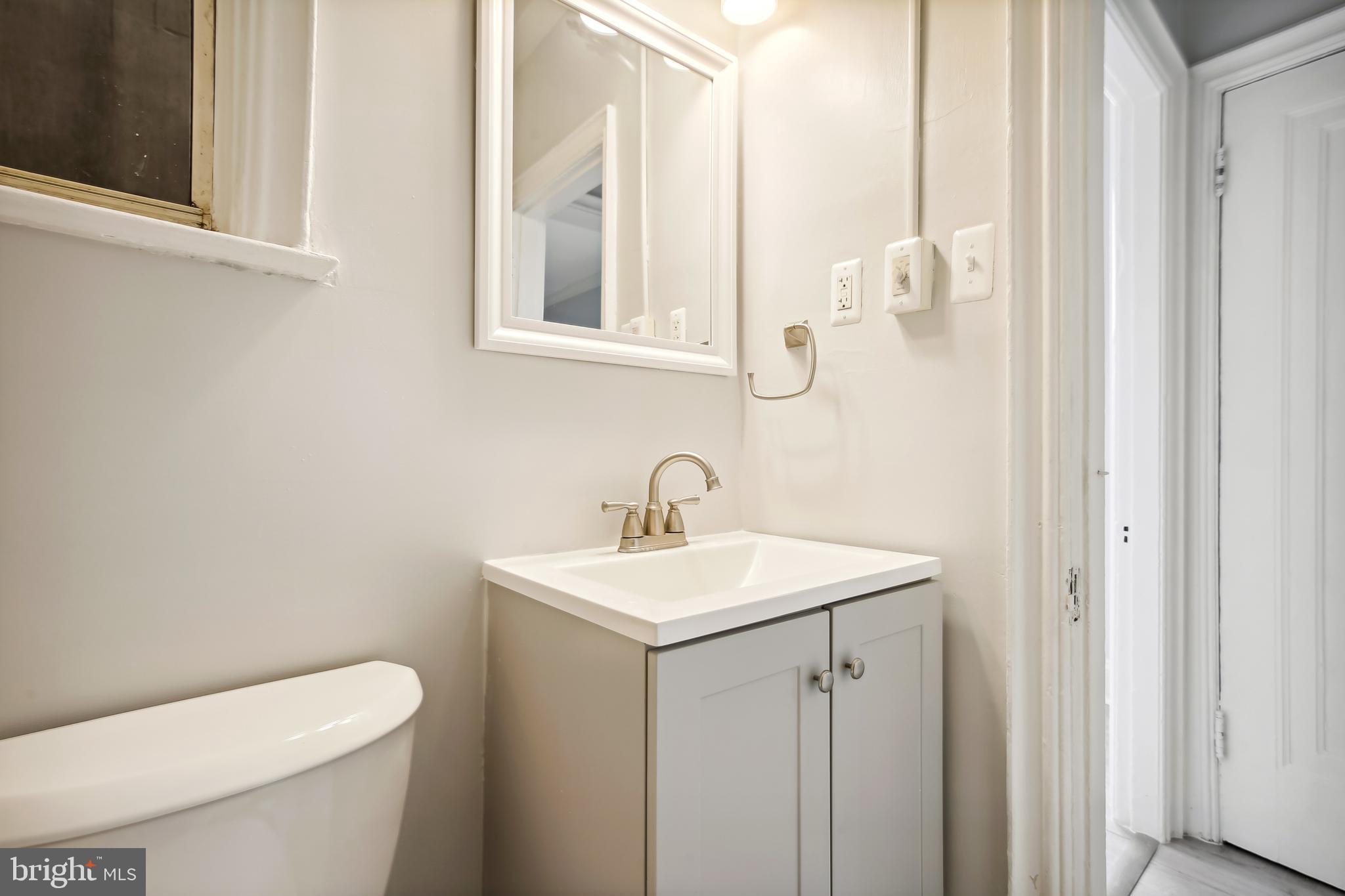 3701 13th Street Northwest, Unit 102 Washington, DC 20010 - Photo 15 of 38 a bathroom with a toilet sink and mirror