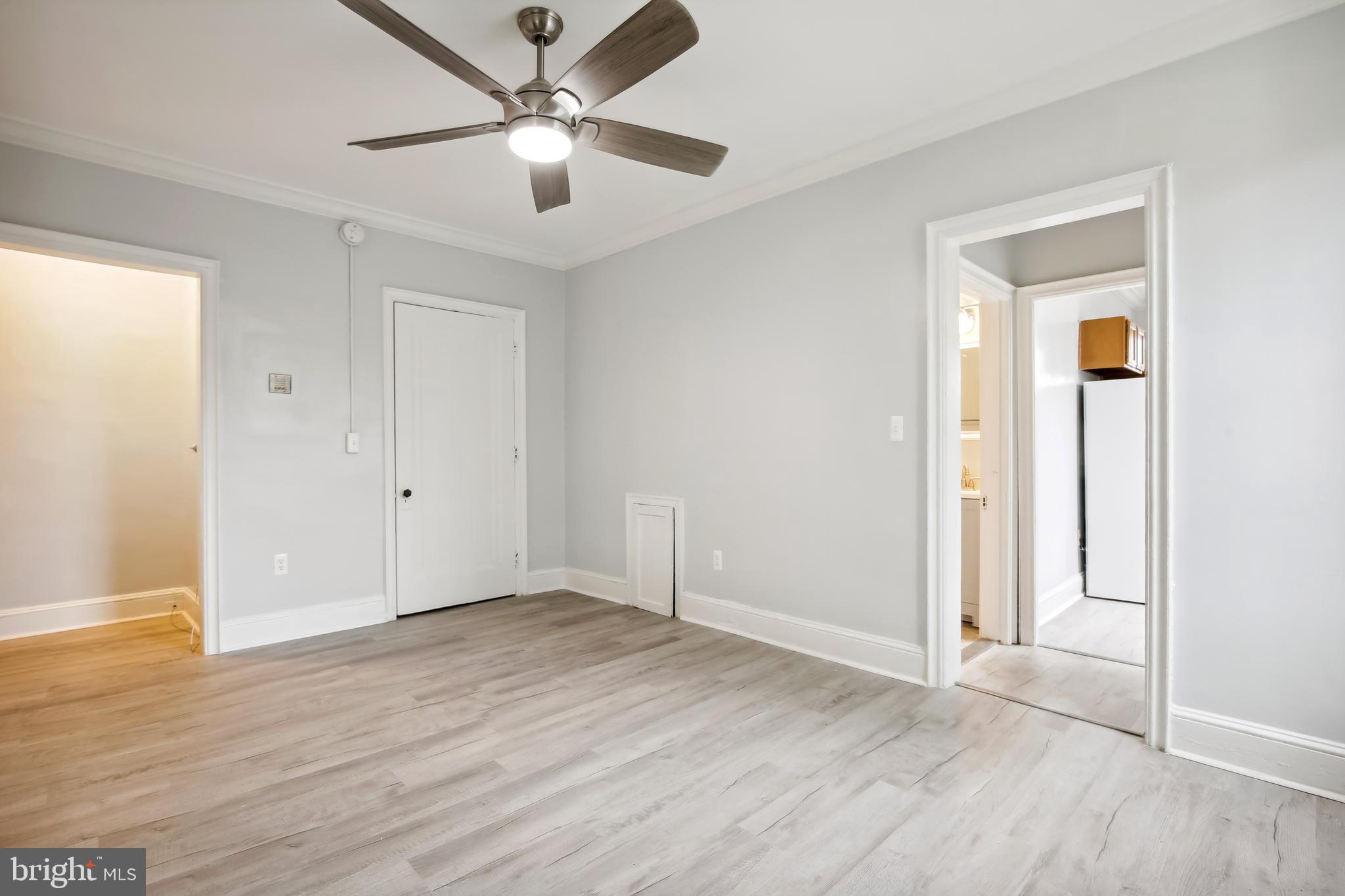 3701 13th Street Northwest, Unit 102 Washington, DC 20010 - Photo 17 of 38 an empty room with wooden floor and ceiling fan