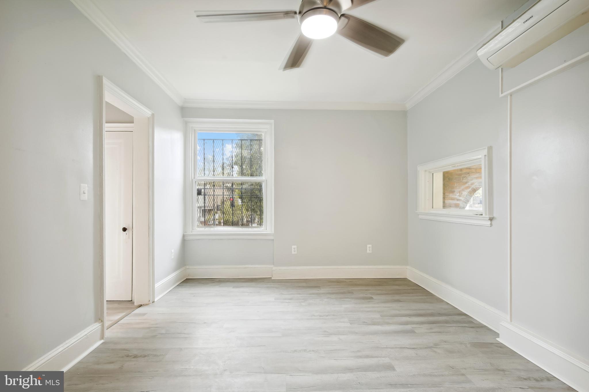 3701 13th Street Northwest, Unit 102 Washington, DC 20010 - Photo 18 of 38 wooden floor in an empty room with a window