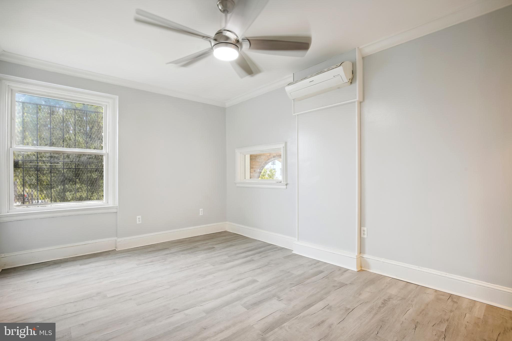 3701 13th Street Northwest, Unit 102 Washington, DC 20010 - Photo 19 of 38 an empty room with wooden floor ceiling fan and windows