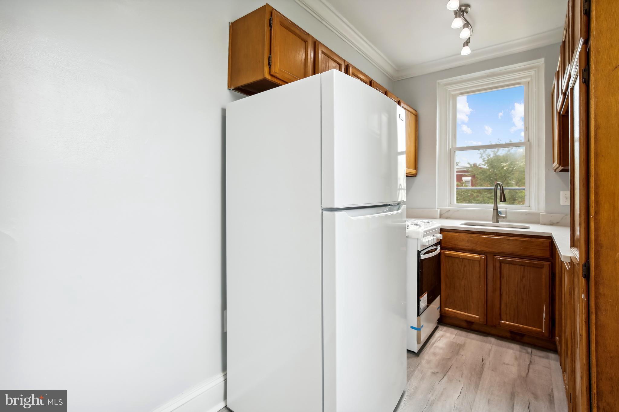 3701 13th Street Northwest, Unit 102 Washington, DC 20010 - Photo 9 of 38 a kitchen with stainless steel appliances a refrigerator and a window