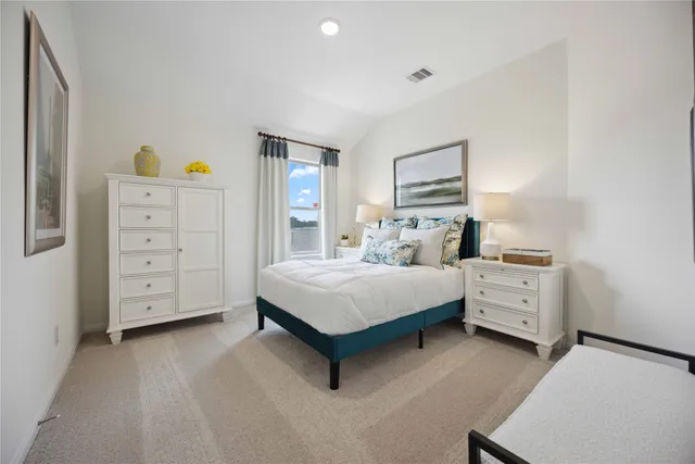 a bedroom with a bed and a couch