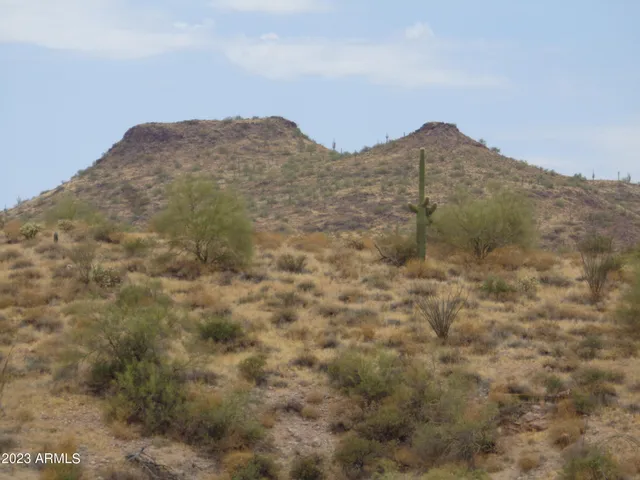 a view of a large mountain with a mountain in the background