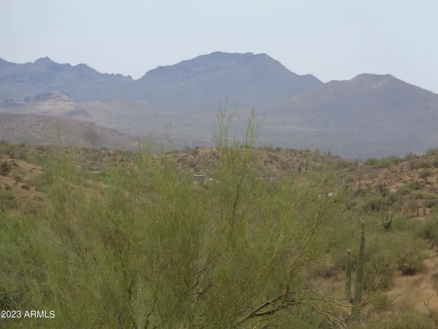 a view of a large mountain with mountains in the background