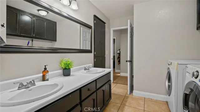 a bathroom with a sink a washer and dryer