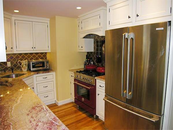 111 Hoover Road Needham, MA 02494 - Photo 11 of 28 a kitchen with white cabinets and stainless steel appliances