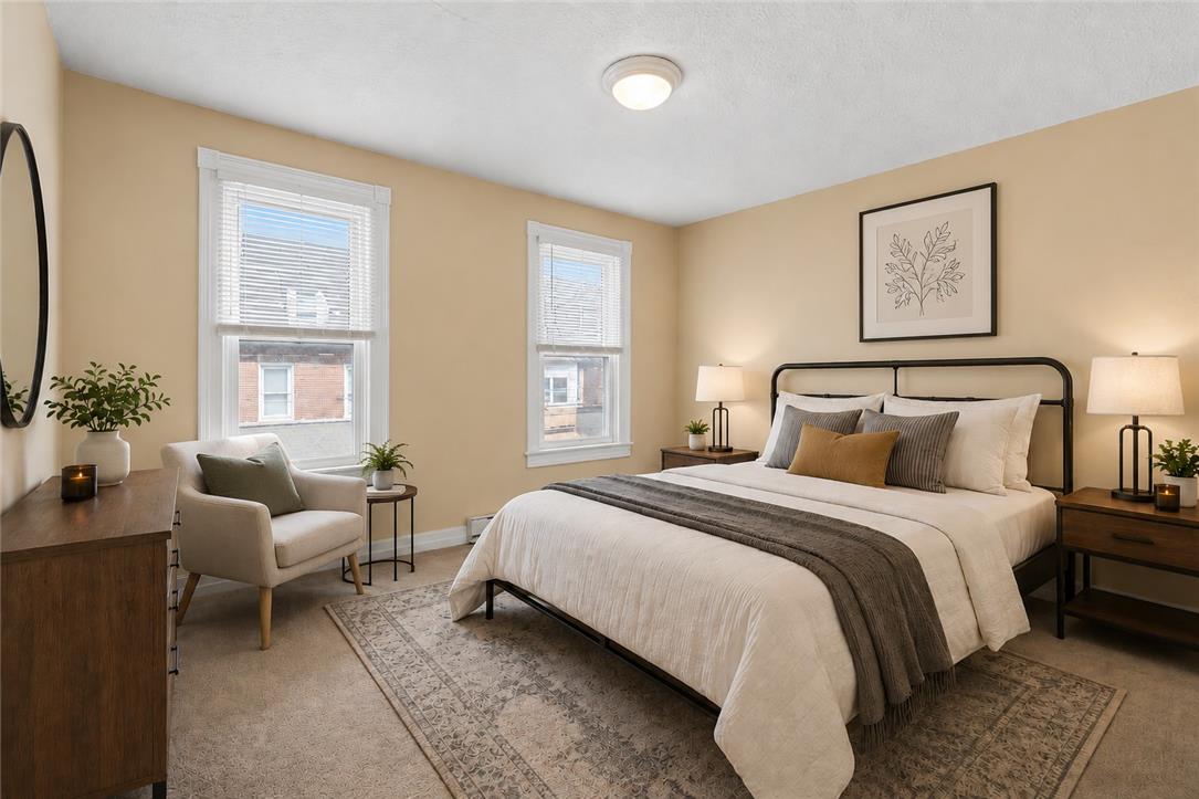 431 Pierce Street Bethlehem, PA 18015 - Photo 12 of 27 This cozy, well-lit bedroom features elegant hardwood window frames and soft, plush carpeting underfoot.