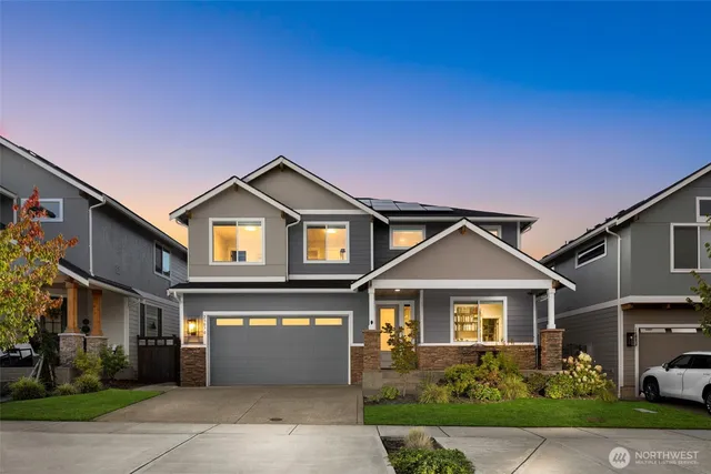 a front view of a house with a yard and garage