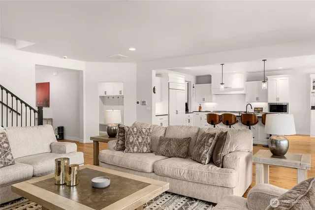 a living room with furniture kitchen view and a dining table