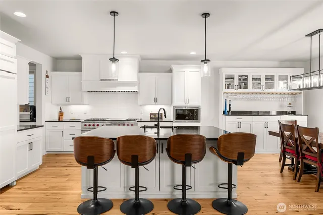 a kitchen with lots of counter space and chairs