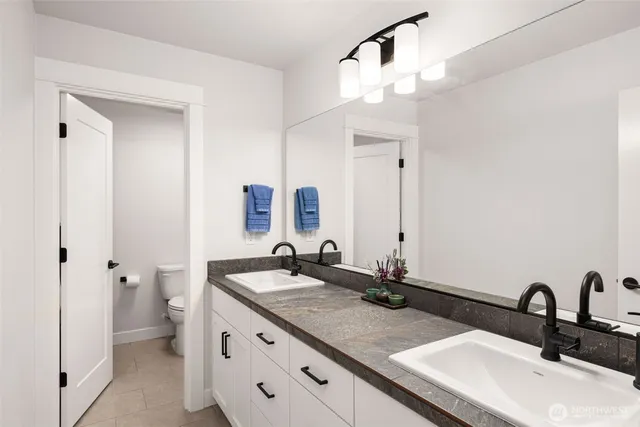 a bathroom with a double vanity sink and a mirror