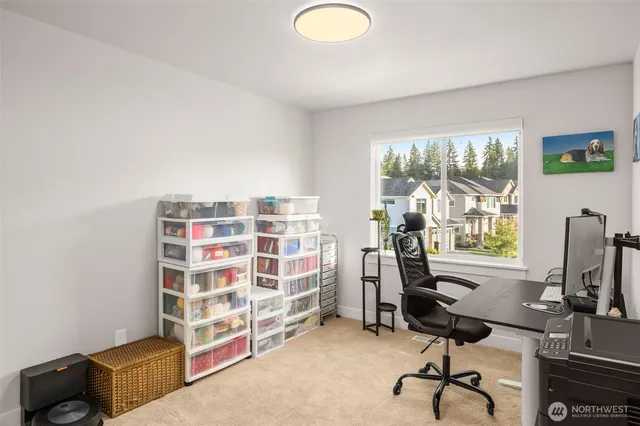 a view of a workspace with furniture and a window