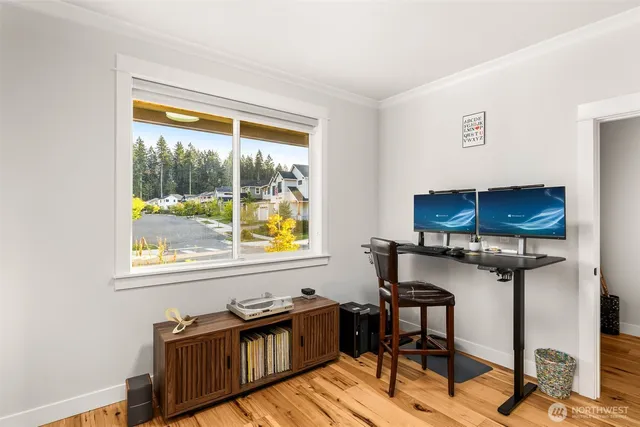 a view of a workspace with furniture and a window