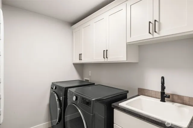 a bathroom with a sink and cabinets