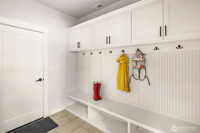 a view of a patio with a table and chairs and a barbeque