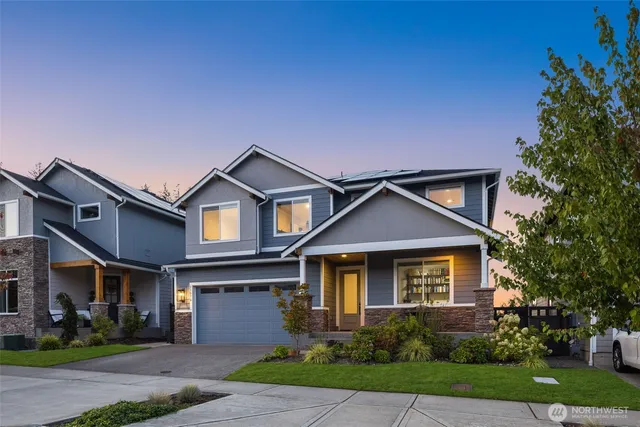 a front view of a house with a yard and garage