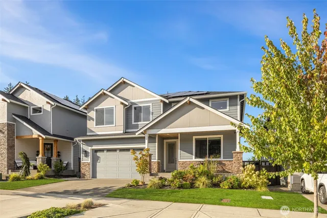 a front view of a house with a yard and garage