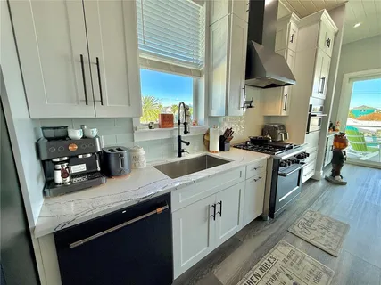 a living room with furniture kitchen view and a refrigerator