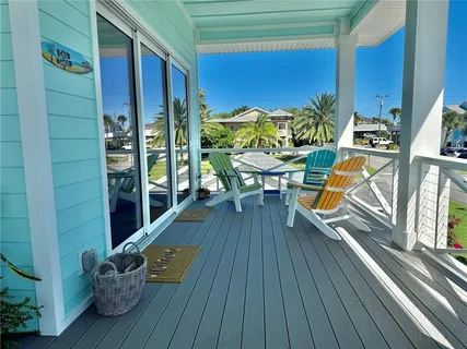a spacious bedroom with a bed and wooden floor
