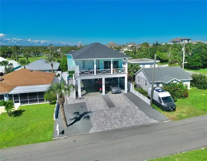 an aerial view of a house with garden space and street view