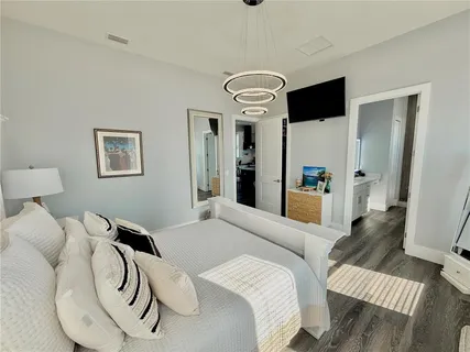 a bathroom with a tub a sink and a mirror