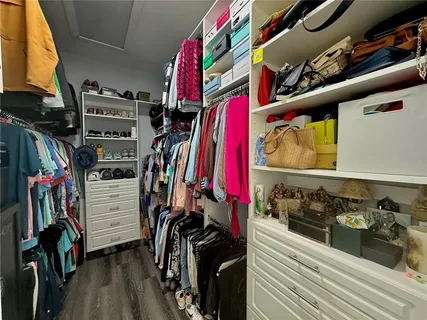 a bedroom with a bed a dresser and book shelf