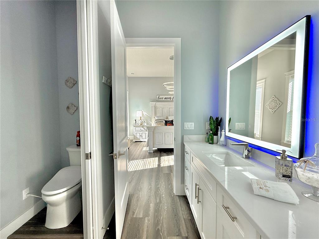 304 North 7th Street Flagler Beach, FL 32136 - Photo 34 of 89 a bathroom with a sink a toilet and a large mirror