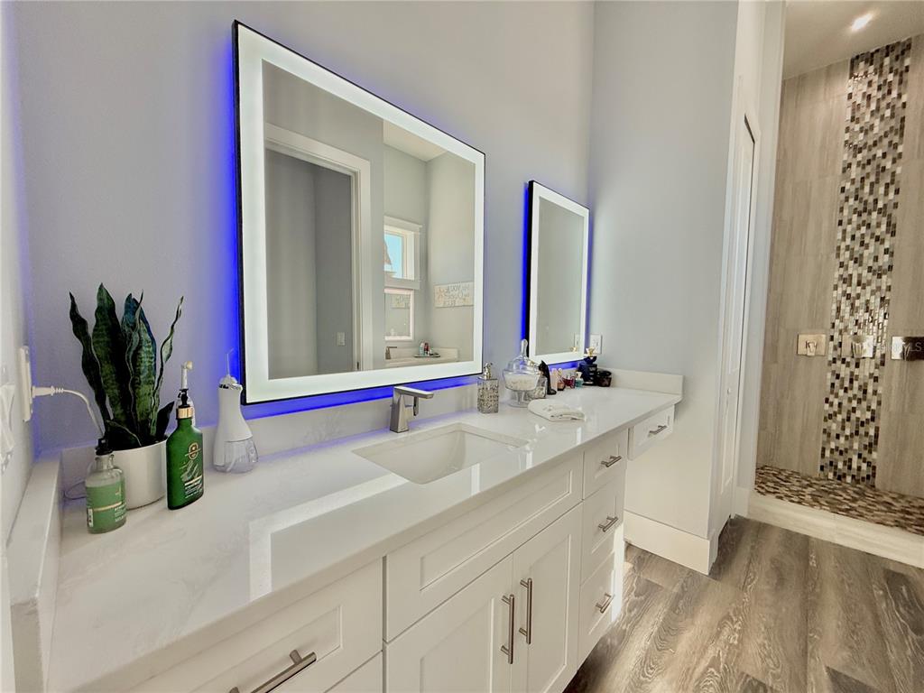 304 North 7th Street Flagler Beach, FL 32136 - Photo 35 of 89 a bathroom with a sink a mirror and a window