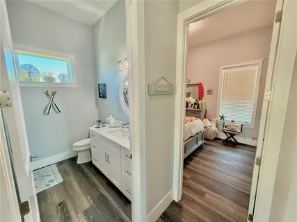 a bathroom with a double vanity sink toilet and mirror