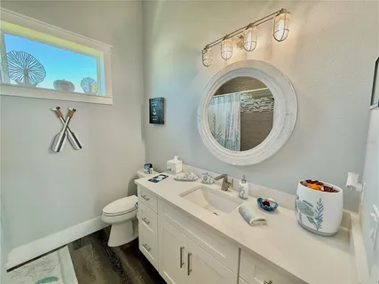 a view of a house with a yard and potted plants