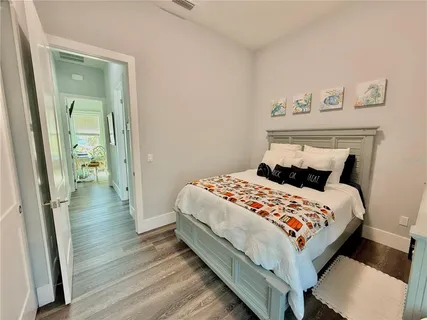 a room with wooden floor and potted plant